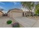 Tan house with a two-car garage and landscaped front yard at 3257 W Five Mile Peak Dr, San Tan Valley, AZ 85144