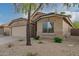 Tan house with a two-car garage and landscaped front yard at 3257 W Five Mile Peak Dr, San Tan Valley, AZ 85144