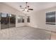 Living room with sliding door to backyard and ceiling fan at 3257 W Five Mile Peak Dr, San Tan Valley, AZ 85144