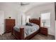 Bedroom with full-size bed and wood dresser at 3301 S Goldfield Rd # 4065, Apache Junction, AZ 85119