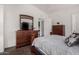 Bedroom with full bed, dresser and view of the laundry room at 3301 S Goldfield Rd # 4065, Apache Junction, AZ 85119