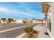 View of street and neighboring homes in a quiet community at 3301 S Goldfield Rd # 4065, Apache Junction, AZ 85119