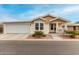 Tan house with white trim, attached garage, and small porch at 3301 S Goldfield Rd # 4065, Apache Junction, AZ 85119