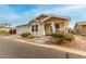 Tan house with white trim, attached garage, and small porch at 3301 S Goldfield Rd # 4065, Apache Junction, AZ 85119