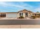 Tan house with white trim, attached garage, and small porch at 3301 S Goldfield Rd # 4065, Apache Junction, AZ 85119