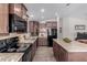 Modern kitchen with island, dark wood cabinets and black appliances at 3301 S Goldfield Rd # 4065, Apache Junction, AZ 85119