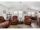 Living room with brown reclining furniture and dining area view at 3301 S Goldfield Rd # 4065, Apache Junction, AZ 85119