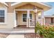 Small front porch with white railing and seating area at 3301 S Goldfield Rd # 4065, Apache Junction, AZ 85119