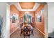 Formal dining room with a wooden table and orange walls at 339 E Horseshoe Ave, Gilbert, AZ 85296