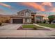 Two-story house with brown exterior, three-car garage, and landscaped yard at 339 E Horseshoe Ave, Gilbert, AZ 85296