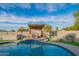 Inviting backyard oasis featuring a kidney-shaped pool, pergola, and patio furniture at 3402 E Sunnyside Dr, Phoenix, AZ 85028