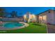 Relaxing backyard with pool, lighting and outdoor dining at 3402 E Sunnyside Dr, Phoenix, AZ 85028