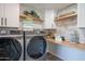 Bright laundry room with modern washer and dryer, and ample counter space at 3402 E Sunnyside Dr, Phoenix, AZ 85028