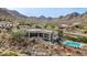 Aerial view of house, showcasing the backyard, pool, and mountain views at 34157 N Mirage Ct, San Tan Valley, AZ 85144