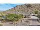 Aerial view of house showcasing its unique architectural design and desert landscaping at 34157 N Mirage Ct, San Tan Valley, AZ 85144