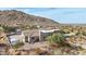 Aerial view showcasing the house's backyard, pool and mountain backdrop at 34157 N Mirage Ct, San Tan Valley, AZ 85144