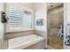 Bathroom features a soaking tub, walk-in shower, and granite countertops at 34157 N Mirage Ct, San Tan Valley, AZ 85144