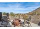 Relaxing firepit area with rocking chairs and mountain view at 34157 N Mirage Ct, San Tan Valley, AZ 85144