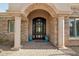 Elegant entryway with arched detail and a large custom door at 34157 N Mirage Ct, San Tan Valley, AZ 85144