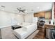 Open living room with sectional sofa and kitchenette at 34157 N Mirage Ct, San Tan Valley, AZ 85144