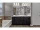 Double vanity bathroom with dark brown cabinets and a large mirror at 3432 E Alfalfa Dr, Gilbert, AZ 85298