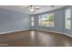 Bright bedroom with wood floors and large window at 3432 E Alfalfa Dr, Gilbert, AZ 85298