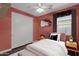 Cozy bedroom with a pink accent wall and built in closet at 3432 E Alfalfa Dr, Gilbert, AZ 85298