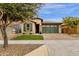 Single-story home with green garage door and landscaped front yard at 3432 E Alfalfa Dr, Gilbert, AZ 85298