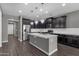 Modern kitchen with dark cabinets and a large island at 3432 E Alfalfa Dr, Gilbert, AZ 85298