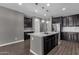 Modern kitchen with dark cabinets and a large kitchen island at 3432 E Alfalfa Dr, Gilbert, AZ 85298