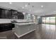 Modern kitchen with island, dark cabinetry, and pendant lighting at 3432 E Alfalfa Dr, Gilbert, AZ 85298