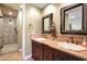 Elegant bathroom with double vanity, large mirrors, and a walk-in shower at 37018 N Tree Lined Trl, Carefree, AZ 85377