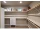 Walk-in closet with custom shelving and hanging rods at 37018 N Tree Lined Trl, Carefree, AZ 85377