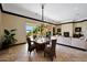 Bright dining area with a chandelier and large windows overlooking the backyard at 37018 N Tree Lined Trl, Carefree, AZ 85377