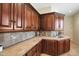 Bright laundry room with wood cabinets and tile countertops at 37018 N Tree Lined Trl, Carefree, AZ 85377