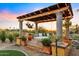 Relaxing pergola with swing bed, creating a tranquil outdoor space at 37018 N Tree Lined Trl, Carefree, AZ 85377