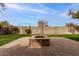 Fire pit in the middle of a grassy backyard at 3718 E Elmington Cir, San Tan Valley, AZ 85140