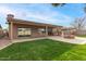 Landscaped backyard with covered patio and fire pit at 3718 E Elmington Cir, San Tan Valley, AZ 85140