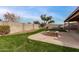 Landscaped backyard with a fire pit and grassy area at 3718 E Elmington Cir, San Tan Valley, AZ 85140