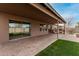 Covered patio with sliding glass doors leading to the backyard at 3718 E Elmington Cir, San Tan Valley, AZ 85140