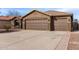 Three-car garage and front yard of a single-story home at 3718 E Elmington Cir, San Tan Valley, AZ 85140