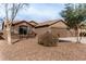 House exterior with a two-car garage and desert landscaping at 3718 E Elmington Cir, San Tan Valley, AZ 85140