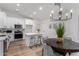 Modern kitchen with white cabinets, stainless steel appliances, and an island at 3718 E Elmington Cir, San Tan Valley, AZ 85140