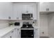 Clean and modern kitchen with white cabinets and stainless steel appliances at 3718 E Elmington Cir, San Tan Valley, AZ 85140