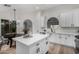 Bright kitchen featuring white cabinets, quartz countertops, and an island at 3718 E Elmington Cir, San Tan Valley, AZ 85140