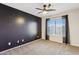 Bedroom with dark accent wall and ceiling fan at 38213 N Raleigh Way, Anthem, AZ 85086