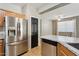 Kitchen with stainless steel refrigerator and ample wood cabinetry at 38213 N Raleigh Way, Anthem, AZ 85086