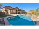 Inviting kidney-shaped pool with a large backyard at 38213 N Raleigh Way, Anthem, AZ 85086