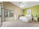 Bright bedroom with carpeted floors and ceiling fan at 40901 N Courage Trl, Anthem, AZ 85086