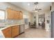 Kitchen with wood cabinets, granite countertops, and a view into the living area at 40901 N Courage Trl, Anthem, AZ 85086